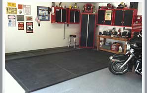 Put a rubber mat under your motorcycle to protect your garage floor